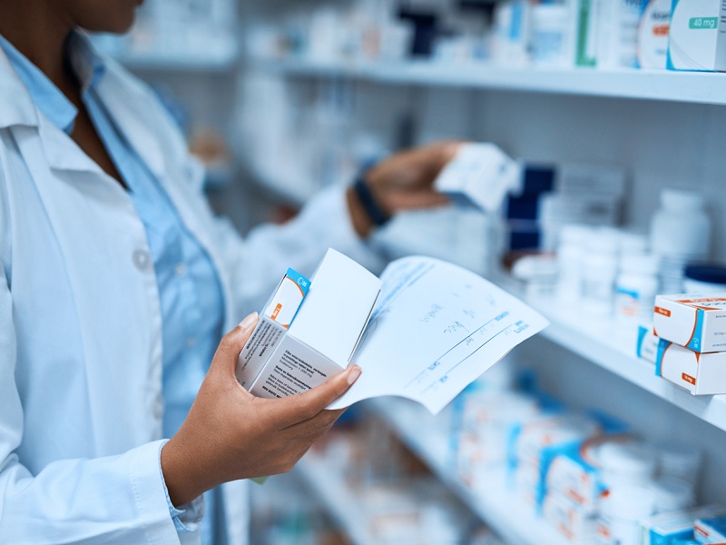 Licensed pharmacist reviewing prescriptions at Our Mall Pharmacy